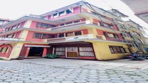 A multi-story building with a ground-level commercial space and upper residential units. - MeroStay 211 Hotel DN (Kathmandu)