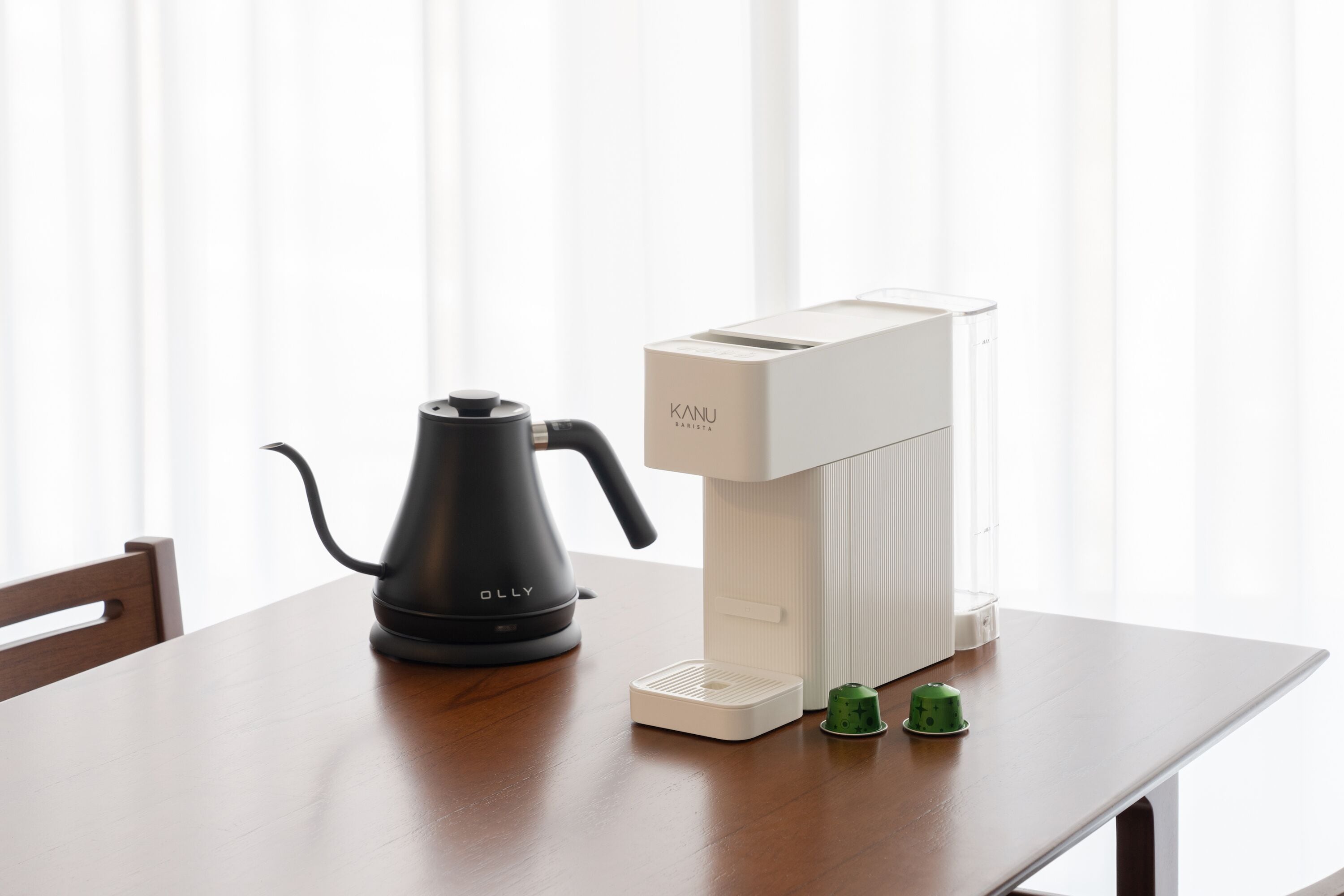 A table with a coffee maker and a water dispenser.
