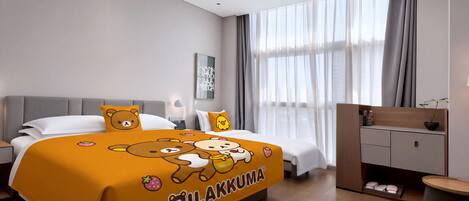 A modern hotel room with a bed, bedside tables, a desk, and a window with curtains.