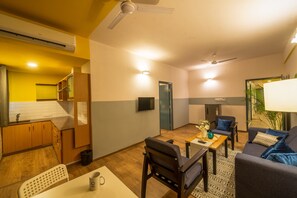 A compact living space with a kitchen, dining area, and seating area. - Olive Hotel Magrath by Embassy Group (Bengaluru)