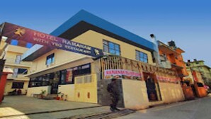 A hotel with a blue roof and a sign that reads "Hotel Raja Mahal with VVIP Restaurant." - MeroStay 141 Hotel RG (Kathmandu)