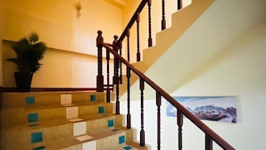 A staircase with wooden balusters and a patterned carpet. - Royal Vista (Patong)