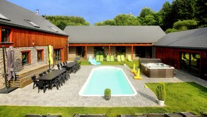 A backyard with a swimming pool, outdoor seating, and a barbecue area. - Beautiful villa with heated outdoor pool (Manhay (lamormenil))