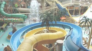 An indoor water park with multiple water slides and pools. - ART B&B (Blackpool)
