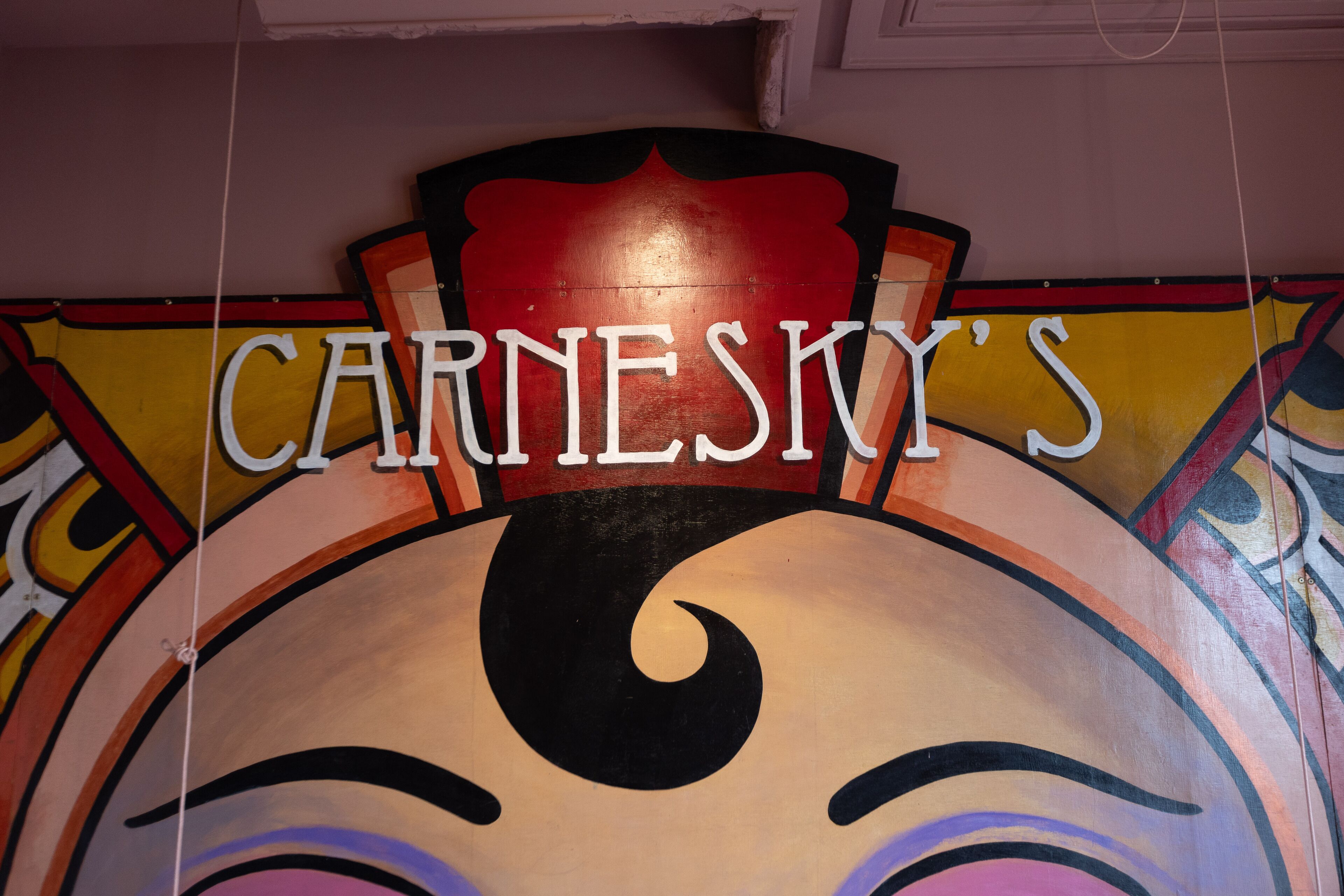 A colorful mural with the text "CARNESKY'S" prominently displayed.
