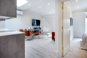 Enjoy a comfortable stay in this stylish room featuring a dining area, flat-screen TV, and a cozy bed.