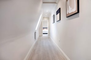 Stylish hallway with framed artworks and recessed lighting.