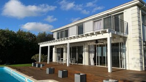 A modern two-story house with a pool, large windows, and a wooden deck. - Gorgeous Mansion by Caesarea's Greatest Beach-hosted by Sweetstay (Hof HaCarmel)