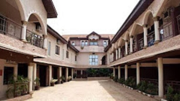 A courtyard with a central open space surrounded by buildings with balconies and windows. - Townhall Hotel & Suites (Lagos)