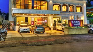 A multi-story hotel with a modern facade, large windows, and a well-lit entrance. - Regenta Place Raysons Kolhapur  (Kolhapur)