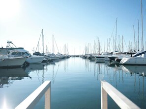 Boats of various sizes and designs are docked in the marina, offering easy access to the water.