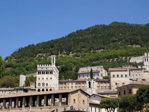 A historic town with medieval architecture, including a prominent tower and fortified buildings.