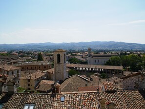 A historic town with traditional architecture, including a prominent tower and a large building with a bell tower.