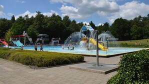 A water park with a pool, slides, and a lifeguard tower. - Holiday Home in Zorgvlied near Drents (Zorgvlied)