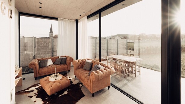 A modern living room with a large window, two sofas, a coffee table, and a dining area. - Modern Dalhem Villa with Views (Dalhem)