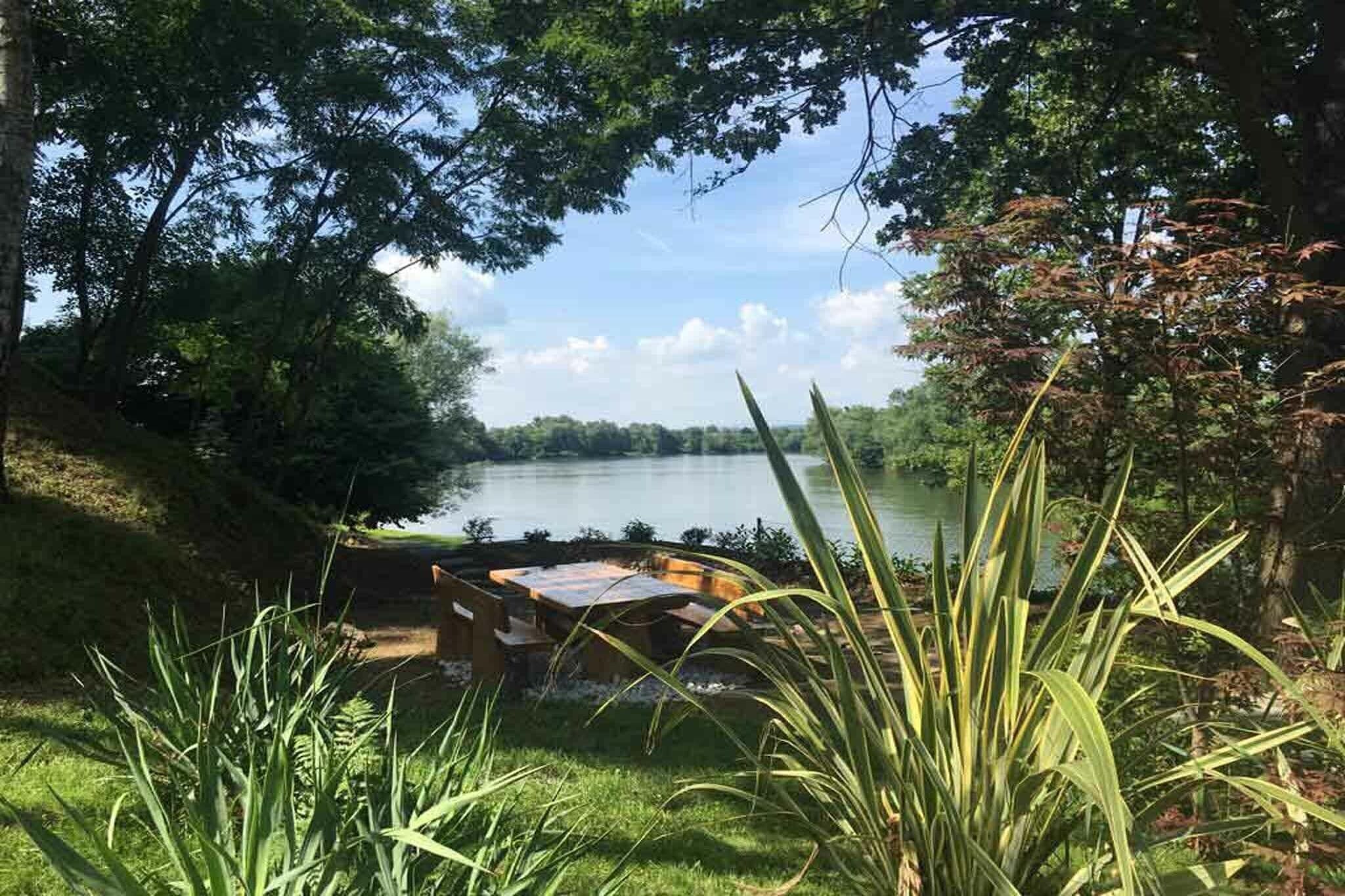 A lakeside view with a dock and a table set up for dining.