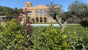 A large, historic building with a courtyard, arched windows, and a swimming pool. - Charming Home Near Vulpellac (Vulpellac)