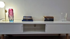 A white desk with a lamp, books, and glasses. - 2 Bed Apartment in Leafy Sandymount, Dublin 4 (Dublin 4)