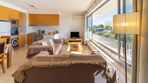 Un apartamento moderno con cocina, sala de estar y un balcón con vistas.