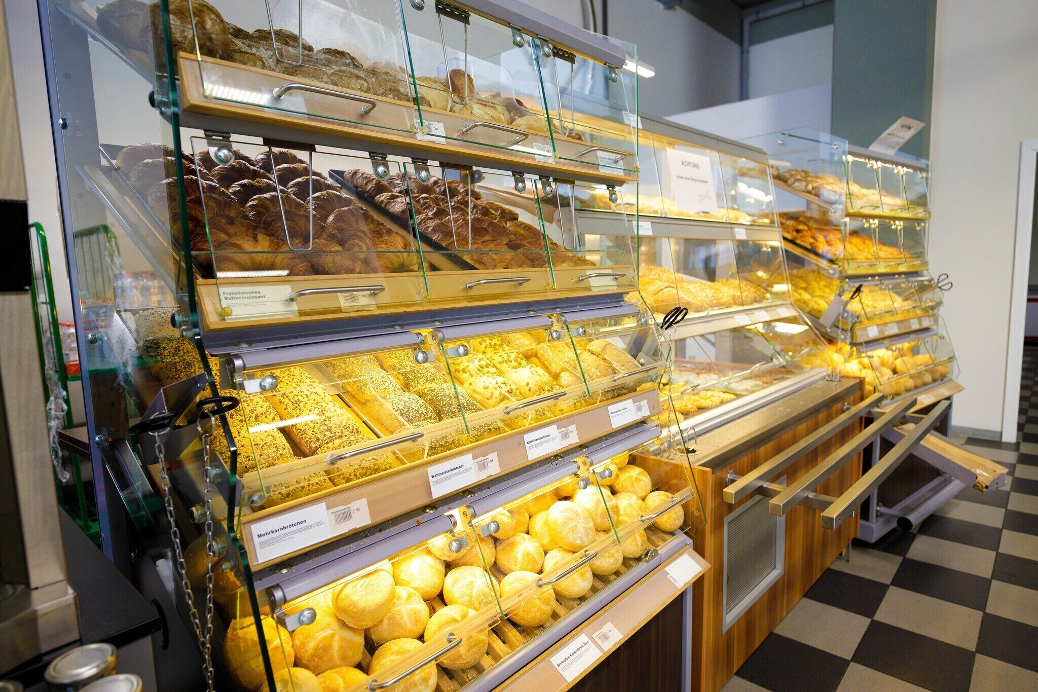 A bakery display with various baked goods in glass cases.