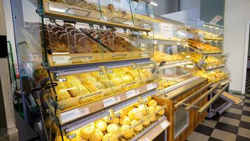 A bakery display with various baked goods in glass cases.