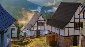 A traditional building with a steep roof, a wooden door, and a small porch area. - Nature Escape in Heimbach (Heimbach)