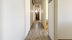 A narrow hallway with wooden flooring and white walls. - Holiday Home in Rogoznica near Beach (Rogoznica)