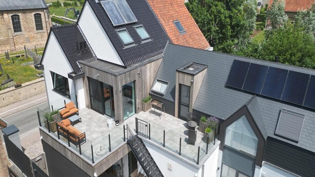 A modern two-story house with a balcony, solar panels, and a large window. - Apartment in Zuienkerke with Terrace (zuienkerke)