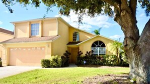 A two-story house with a garage, a front yard, and a large tree. - Ref 417.  Stunning villa in perfect location Close to Disney (Four Corners)