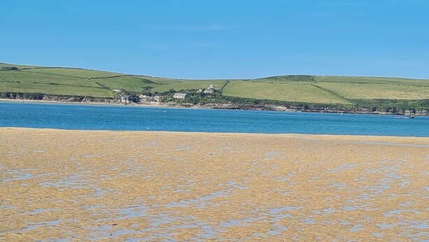 A beach with a sandy shore and a view of green hills in the background. - Boutique Family Home, Garden, Parking 3 cars, 2 Living Rooms. Cornwall (Wadebridge)