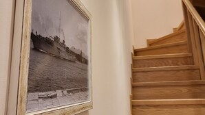 Portaat, joissa on puiset askelmat, ja seinällä mustavalkoinen kehystetty valokuva.