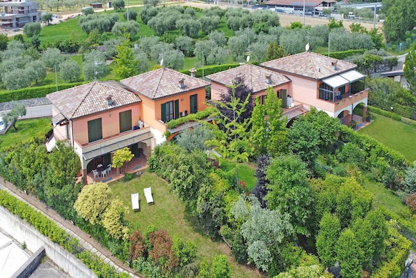 A residential property with a patio, a covered outdoor seating area, and a well-maintained garden.