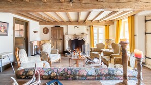 A traditional room with exposed wooden beams, a fireplace, and classic furniture. - Welcoming holiday home in Vresse-sur-Semois with terrace (Vresse-sur-Semois)