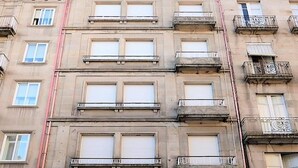 A multi-story building with balconies and windows.
