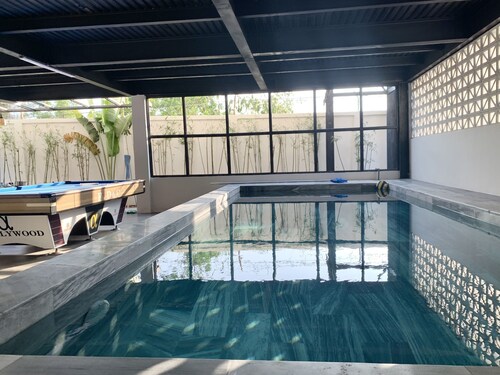 A Spacious 5-bedroom House With a Pool, Beach Front, Close to the City Center