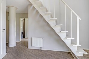 Stunning staircase leads to an upper level, set against a neutral-toned backdrop.