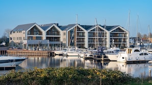 A marina with modern buildings and boats docked.