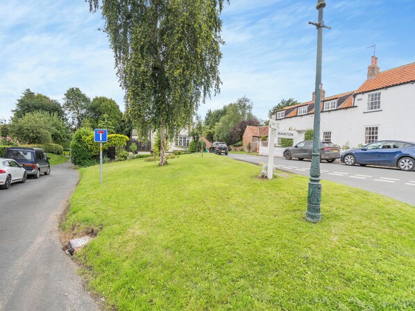 A residential street with a signpost indicating the name 'BAINTON.'