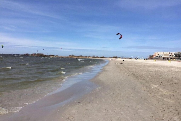 A beach with a sandy shore and calm water.