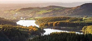 A panoramic view of a valley with a river, a bridge, and dense forested areas. - 2-bed House in Macclesfield Cheshire (Macclesfield)