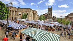 A bustling outdoor market with striped canopies and a historic building in the background. - 2-bed House in Macclesfield Cheshire (Macclesfield)