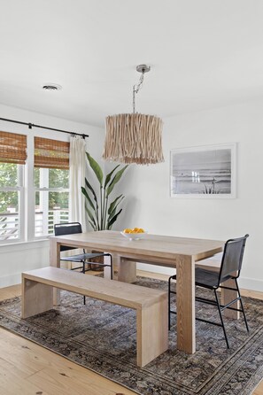 A dining area with a wooden table, bench, and chairs.