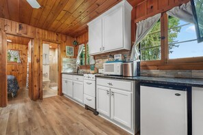 Enjoy cooking and dining in this well-equipped kitchen with a stove, microwave, and refrigerator.