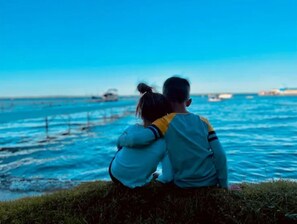 Couples can enjoy serene views of the water from this scenic outdoor spot.