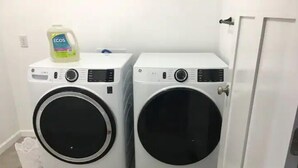 Two front-loading washing machines in a laundry room with a bottle of detergent on top. - Entire house in the quiet town of Fort Shaw (Fort Shaw)