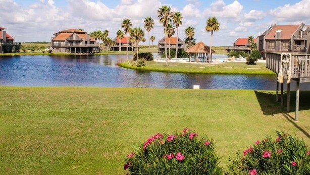 A waterfront property with multiple buildings, a lake, and well-maintained lawns. - Oceanview, Updated, Wi-Fi , Pool.  Family Unit for 6 -  Must be 25+ to rent. (Matagorda)