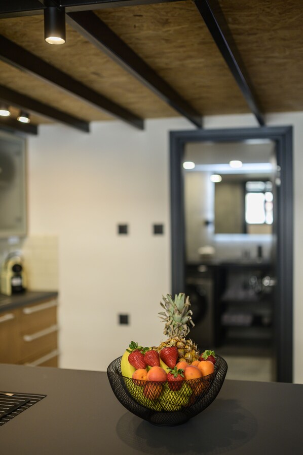 A modern kitchen with a fruit bowl on the counter.