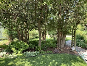 Enjoy a serene garden oasis with lush greenery and a, secure space.