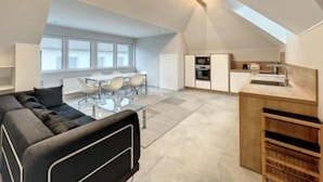 A modern loft apartment with a dining area, kitchen, and living space. - 2 bedrooms in the heart of Limpertsberg (Luxembourg City)