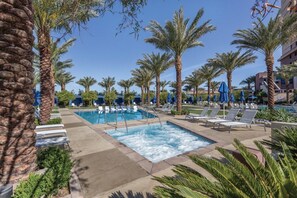 A pool area with lounge chairs and umbrellas, surrounded by palm trees. - Las Vegas | Couples Skyline Lights & Strip Fun | Pool + Cabanas (Las Vegas)